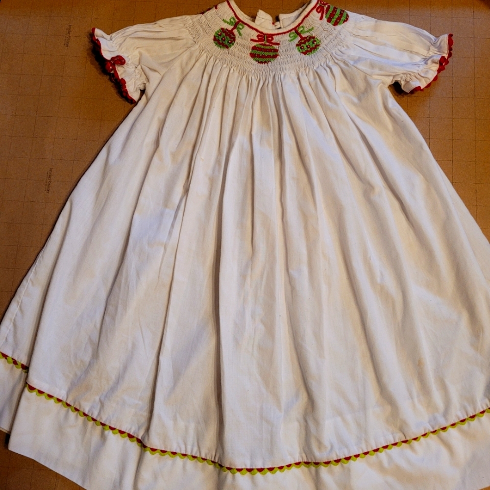 Royal Girl 2T Bishops white dress w/ ornaments Smocked w red /green around bott.